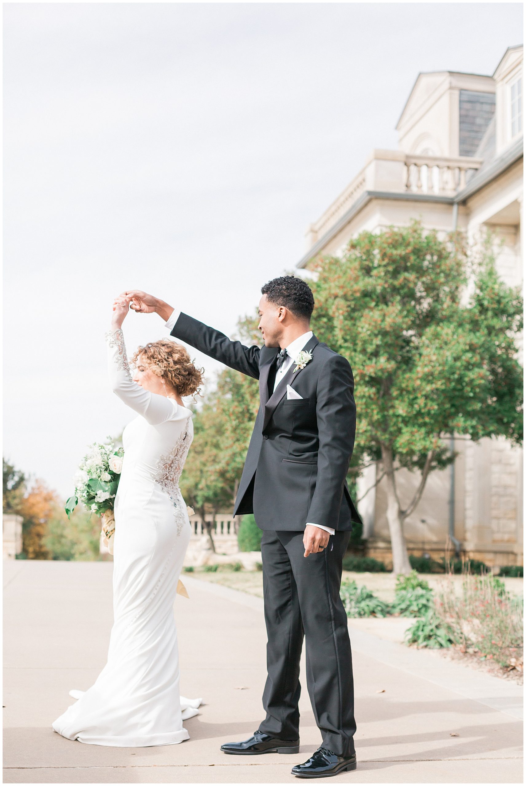 couple dancing in front of gorgeous wedding venue