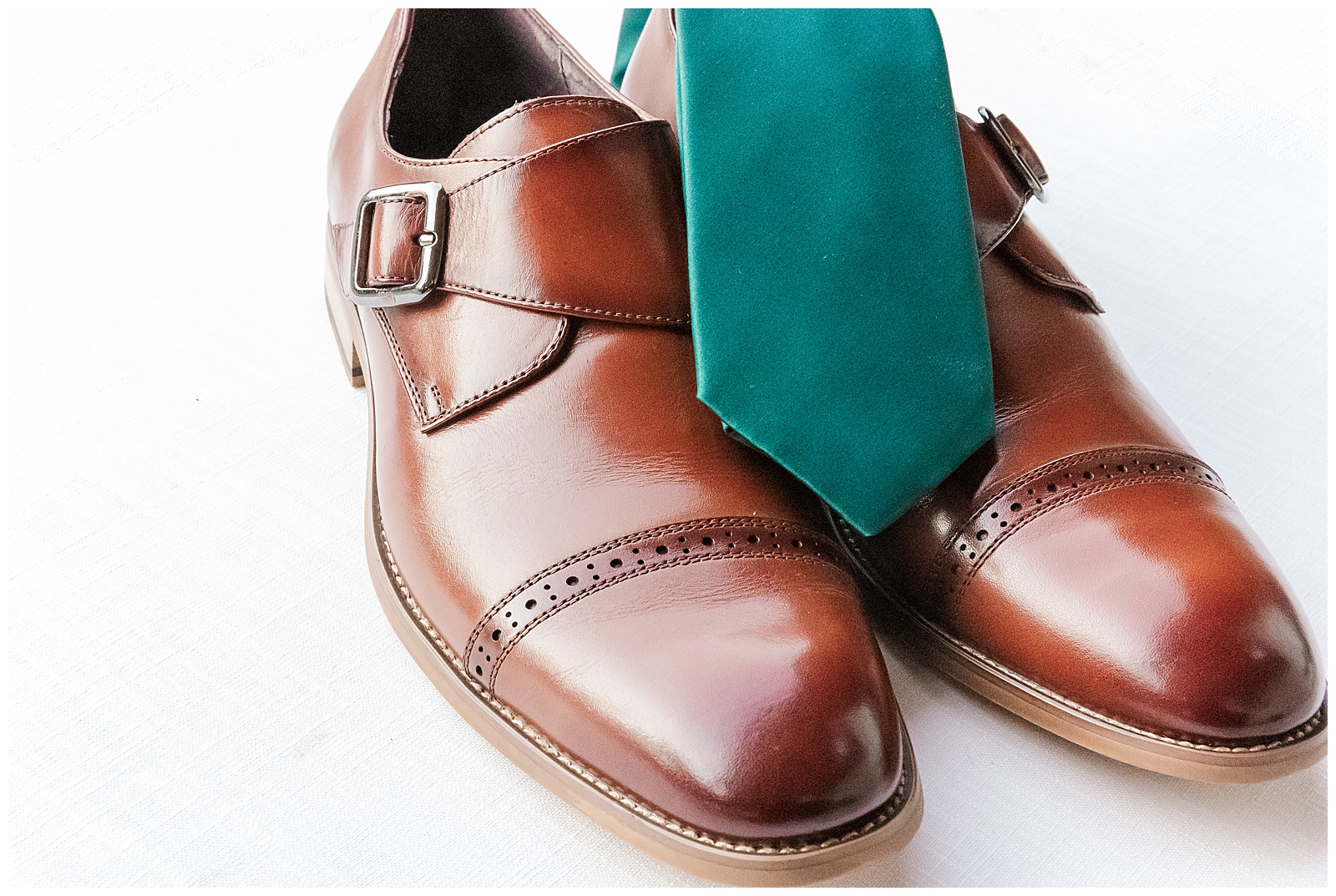 Brown groom shoes with green tie