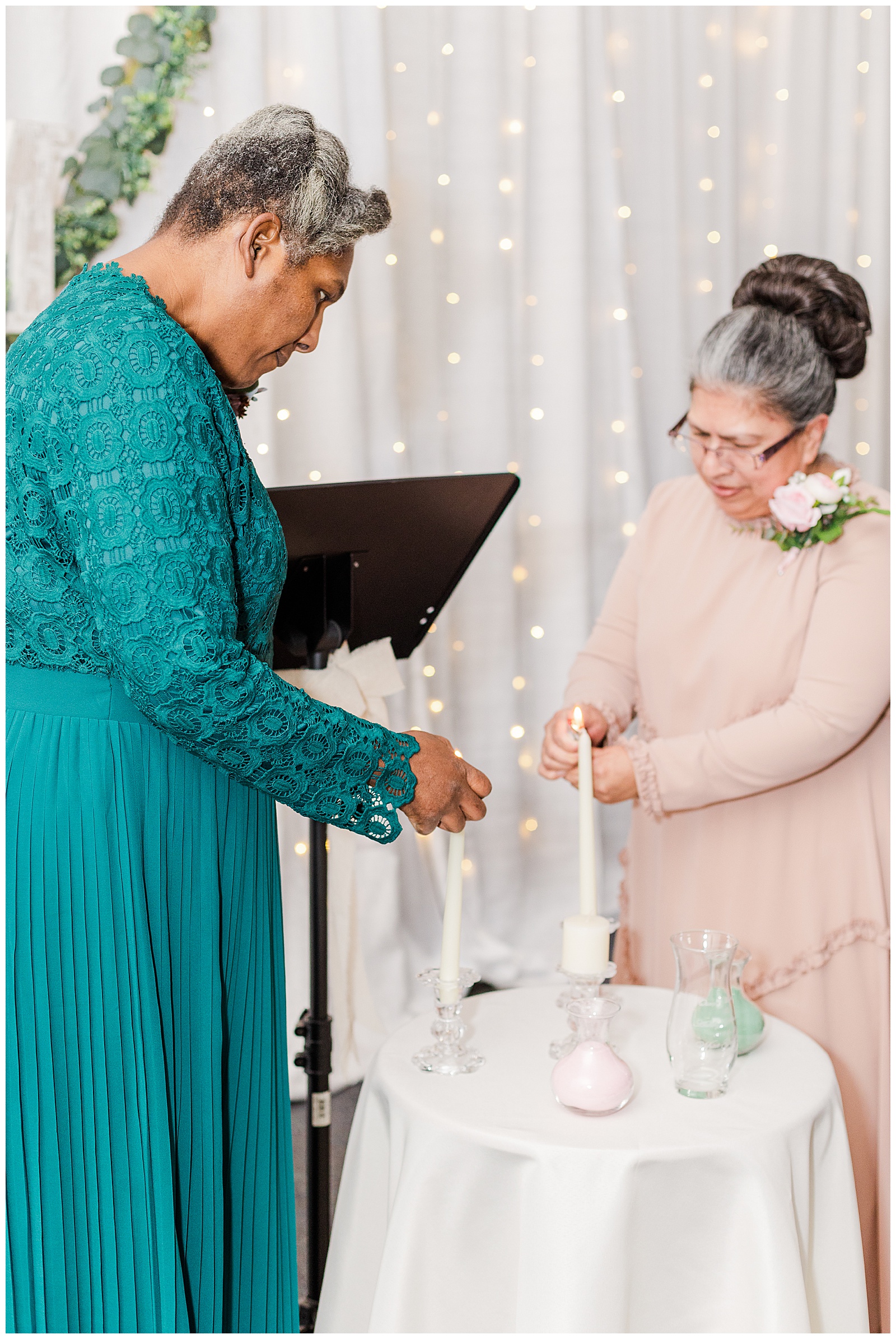 Mother of bride and mother of groom lighting unity candles