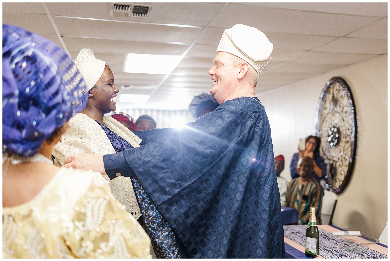 Groom uncovering bride's head at Nigerian reception