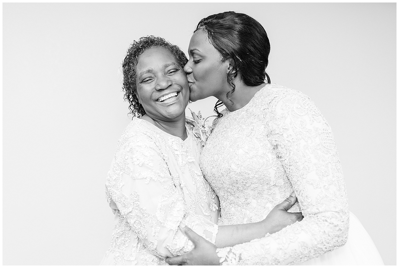 Nigerian bride kissing her mom