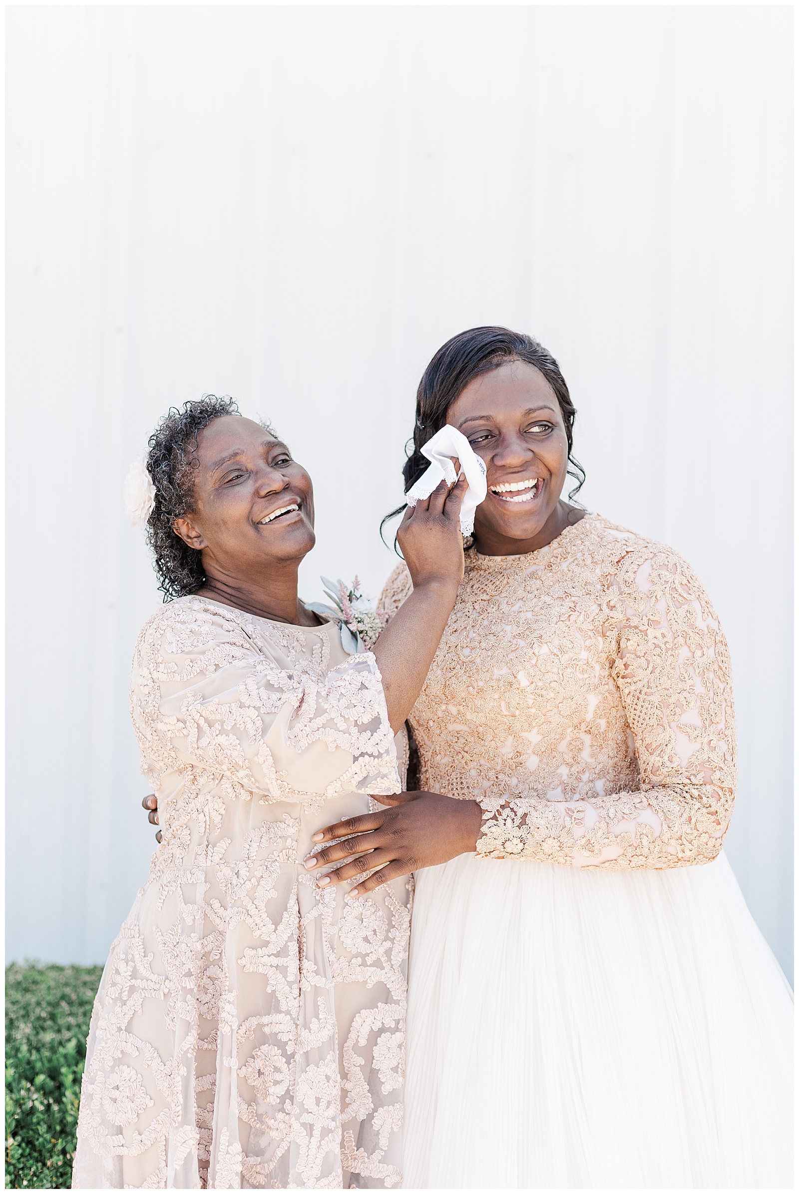 Mother of bride wiping brides tears
