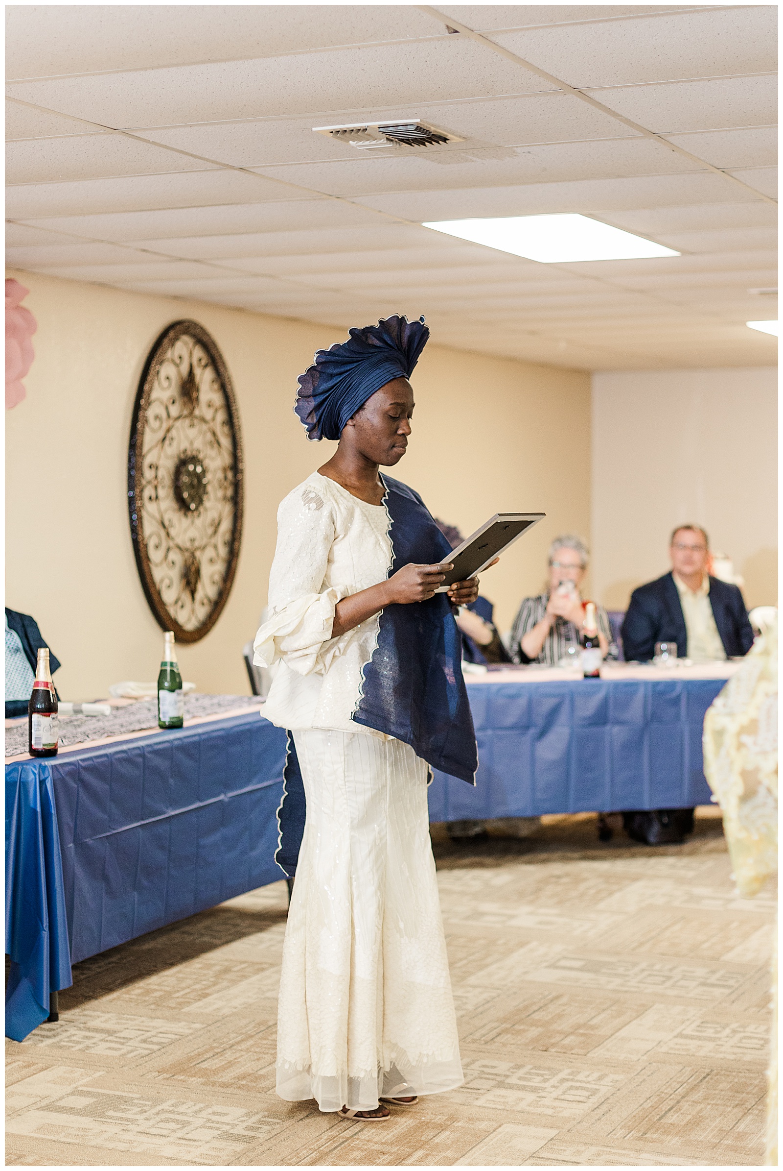 Bride's sister reading letter at Nigerian reception